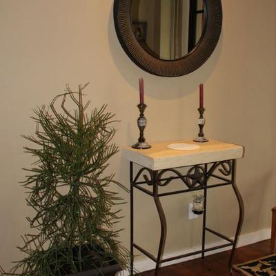 stone slab entry table, candlesticks, mirror, plant
