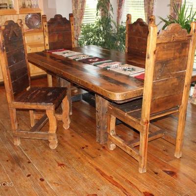 Dining table. Handmade 17th century barn wood, detailed with hand hammered copper and iron trim. With 8 chairs, (4 not pictured)
