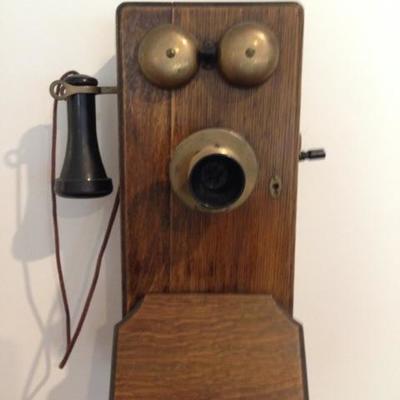 1950s rotary phone inside 1900s crank phone