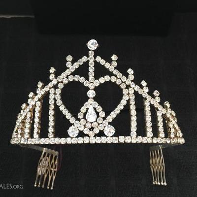 Sparkly tiara from a beauty pageant is priced under $20.00.  Any little princess would be delighted to be crowned with it.