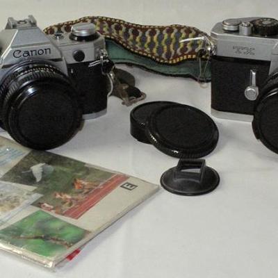 Vintage Canon AE1 35mm Camera with  instruction booklet and TX 35mm Canon Camera, both with FD 50mm Lens 