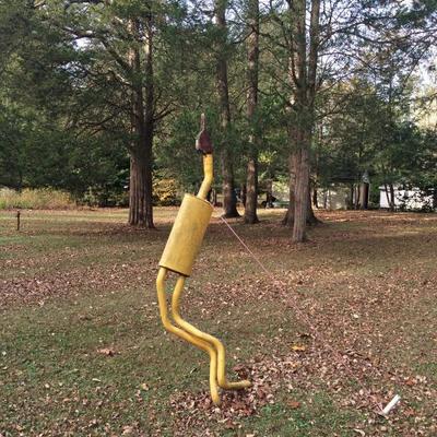 Quirky lawn ornament made from a muffler & found wood