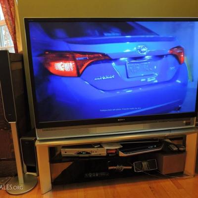 Large TV with Surround Sound Speakers and Stand
