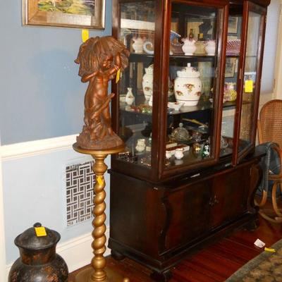 Oriental clay pottery, wooden plant stand, resin statue, Empire china cabinet, framed art.