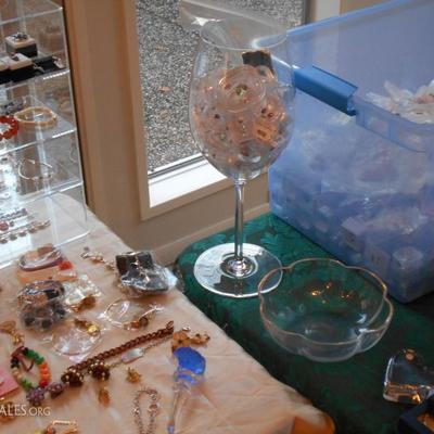 Many loose gemstones in display boxes.