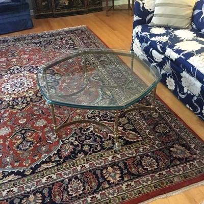 Oriental rug and 1/4 inch glass and brass coffee table, both for sale. Excellent condition!