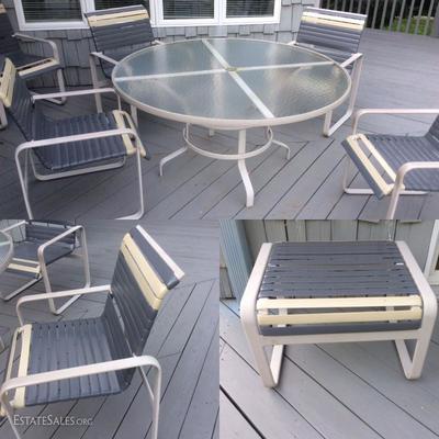Glass table, five chairs and a foot stool patio set. The chairs were recently custom made with the highest quality material