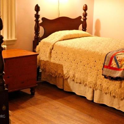 twin poster beds with acorn finials, crocheted spreads, antique blanket chest, antique quilts