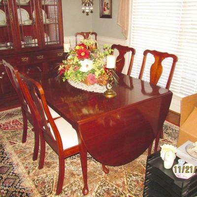 LARGE FORMAL DINING ROOM TABLE WITH FOLD DOWN ROUNDED END LEAFS AND CLOTH BOTTOM WOOD CHAIRS--THIS SET IS VERY VERY CLEAN AND GENTLY USED...
