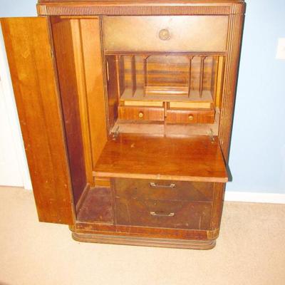 ANTIQUE CLOTHES WARDROBE WITH BUILT IN SECRETARY THAT HAS A FOLD DOWN SHELF AND LOTS OF STORAGE INSIDE--THIS IS A VERY UNIQUE ITEM THAT...