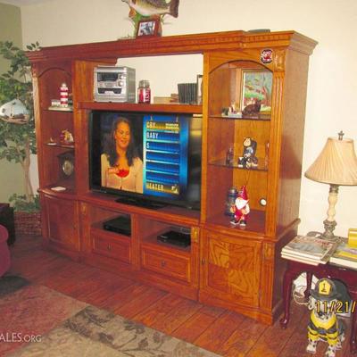 WOOD TV AND FIGURINE CABINET WITH LOTS OF STORAGE SPACE.  THIS RATHER LARGE UNIT WILL SEPARATE INTO 3 PIECES FOR AN EASIER MOVE TO YOUR...