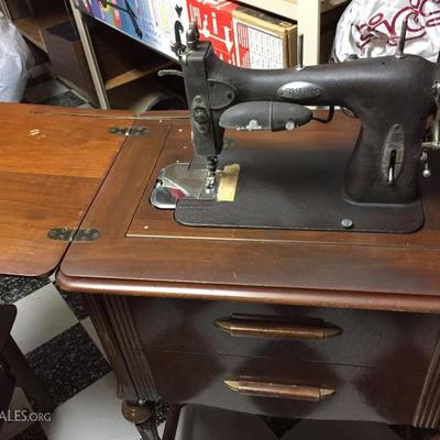 Vintage white sewing machine and cabinet