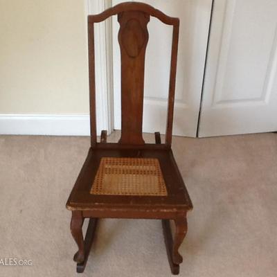 Lot 051. Small Antique Wooden Rocker.

 

Small antique wooden rocker with cane seat. Worn condition, well used with scuffs, scrapes and...