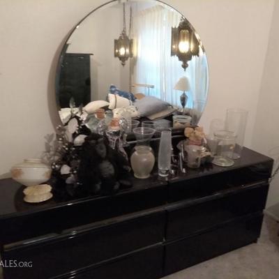 Dark cherry wood dresser w/ round mirror, decorative vases, vintage hanging lamps, decorative pottery