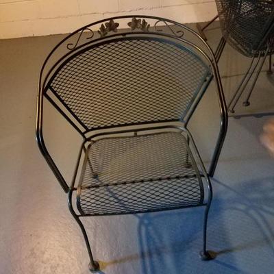 One of four chairs with glass and metal patio set