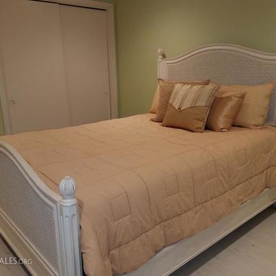 Queen-sized bed with cane headboard. Bedding sold seoparately.
