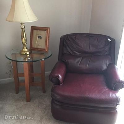 MCM Glass Top Round Side Table next to Vintage Leather Recliner in Burgundy