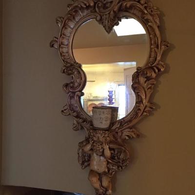 Ornate cherub-framed mirror