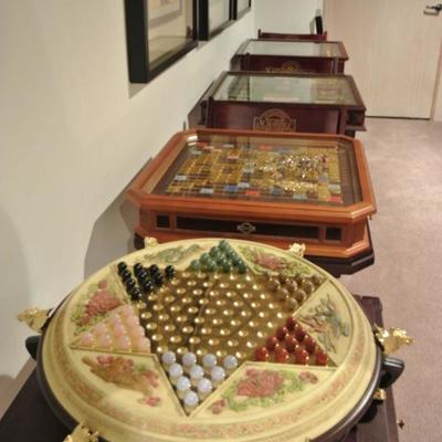 Collectible board games in cases, including Chinese Checkers, Clue, and Monopoly.