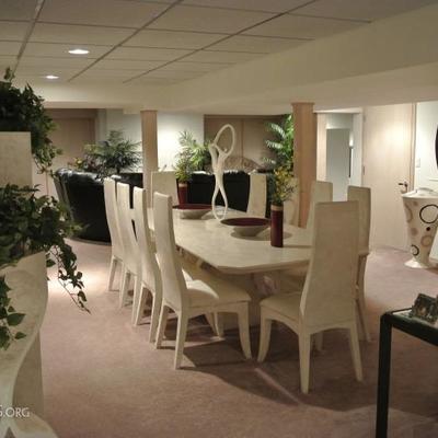 The basement dining area, complete with Marquis Collection of Beverly Hills dining set, shelving units, mirrors and floor vases.