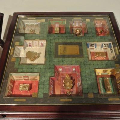 Clue in a collectible case with board game table.