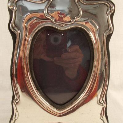 Sterling English Art Nouveau Style Heart Shaped Frame
The hallmark shows the English lion. It measures 7 ¾ X 5 ¾”. 
$98