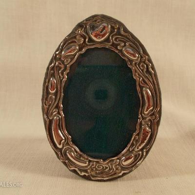 Oval English Sterling Frame on Velvet Back
This measures 3 ¾ X 2 ¾”. The hallmark is CEW English lion. 
$40