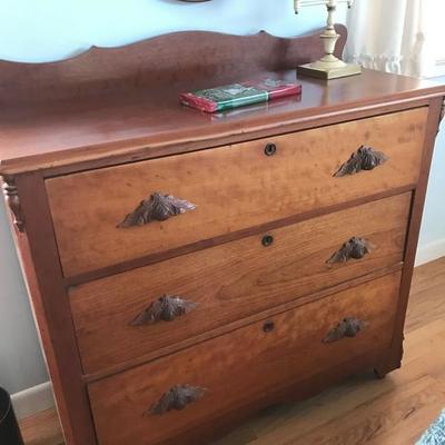 c1880 three-drawer chest of drawers with carved drawer pulls