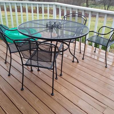 heavy metal patio table and four matching chairs