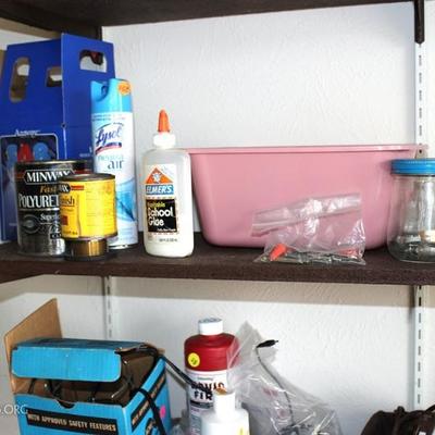 Three shelves of miscellaneous garage items
