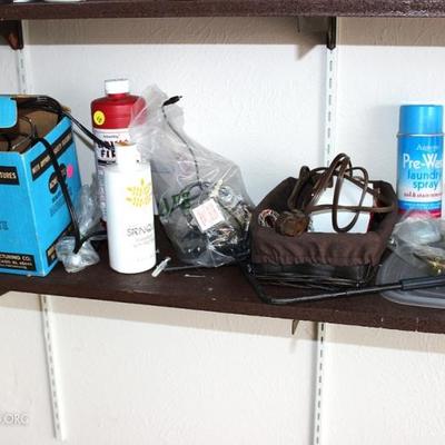 Three shelves of miscellaneous garage items

