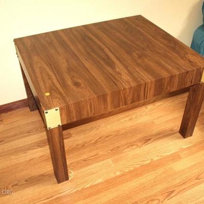 End table with brass corner accent
