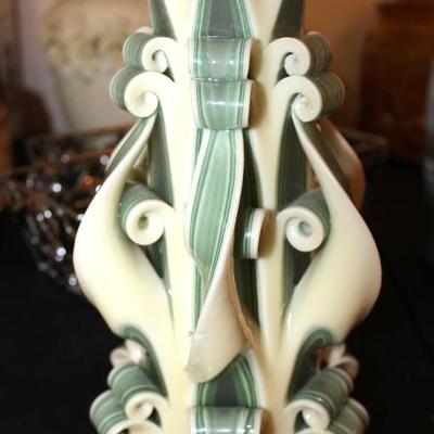 A wax candle mold with plastic base center
