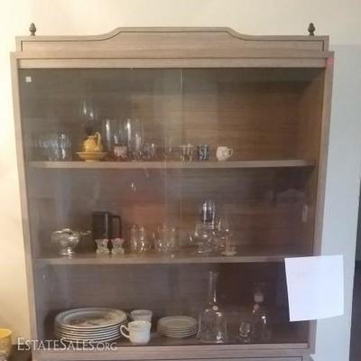 Vintage three shelved china cabinet with sliding glass doors and cabinets below. Original hardware.
