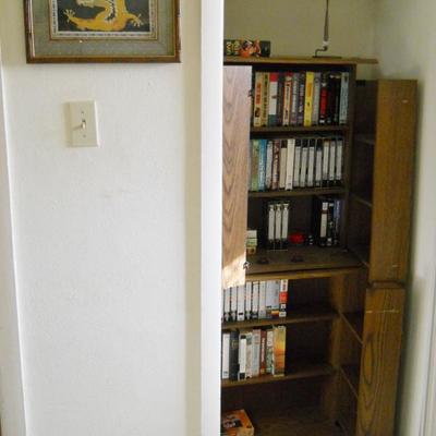 VHS movies, storage cabinets, framed art