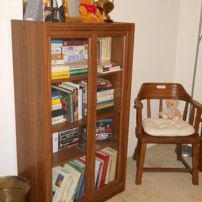 glass door bookcase, books, captain's chair, etc.