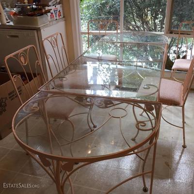 Pink wrought iron and glass table with two rounded extensions and 6 chairs