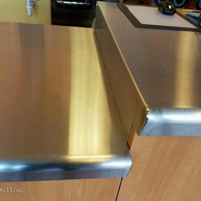 Three sections of metal front counter with stainless steel top. Two sections have drawers and measur