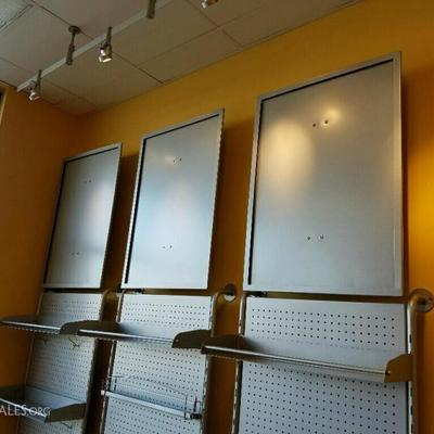 three sections of brushed nickel wall display  
