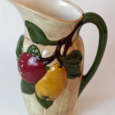 variety of ceramic serving pieces, including pitchers, bowls, & platters