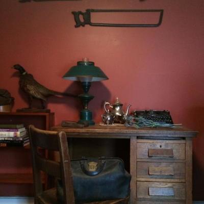 Collection of vintage saws, oak desk & chair, taxidermy pheasant, typewriter, toleware lamp