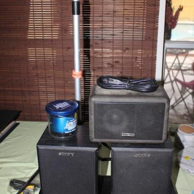 Two sony speakers, sony blue ray DVD player, stand, and jambox
