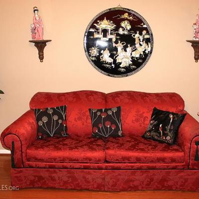 Red sofa and Asian decor including an antique black lacquered round wall art. 3 generations old