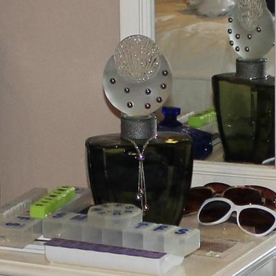 Perfume bottle, sunglasses, pill boxes