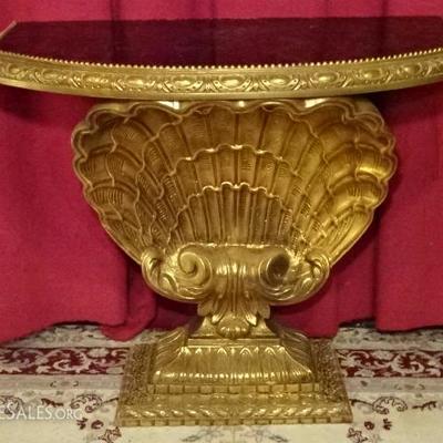 MID CENTURY GILT WOOD CONSOLE TABLE WITH SCALLOP SHELL BASE AND BLACK GLASS TOP