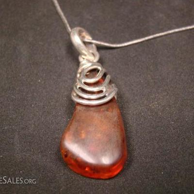 Silver necklace with amber stone.  Amber stone approximately 10 - 17 mm wide and 35 mm long.  16