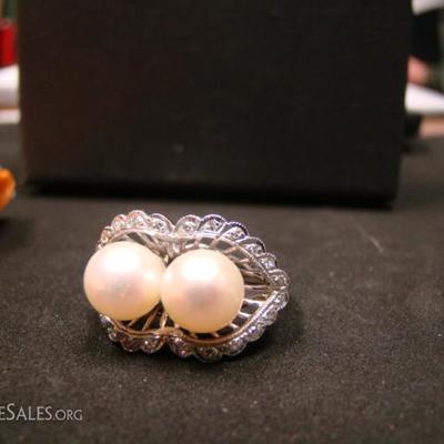 Ladies 14 kt. white gold ring.  2 pearls, each about 7 mm diameter.  Surrounded by 24 small diamonds. 