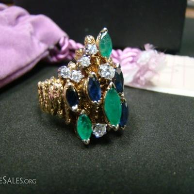 Ladies custom made 18 kt. yellow gold dress ring.  Contains (1) Marquise cut emerald .73 ct, (2) Marquise cut emeralds .57 ct each, (2)...