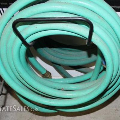 Two garden hoses with brass valve attachments