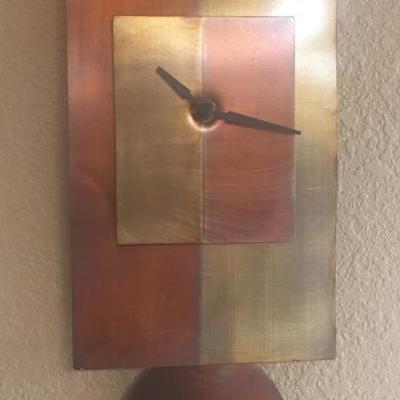 Metal wall clock with pendulum 